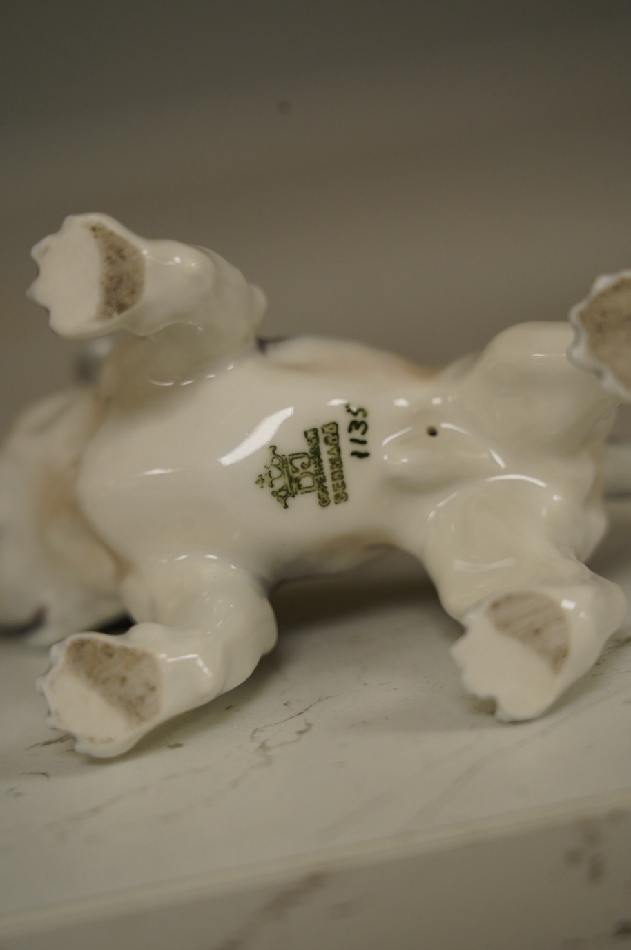 An early Bing & Grondahl figure of a Japanese Chin 12cm high, and a Dahl Jensen small bulldog, 7cm high. Condition - good
